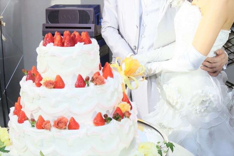 ウェディングケーキに入刀する新郎新婦